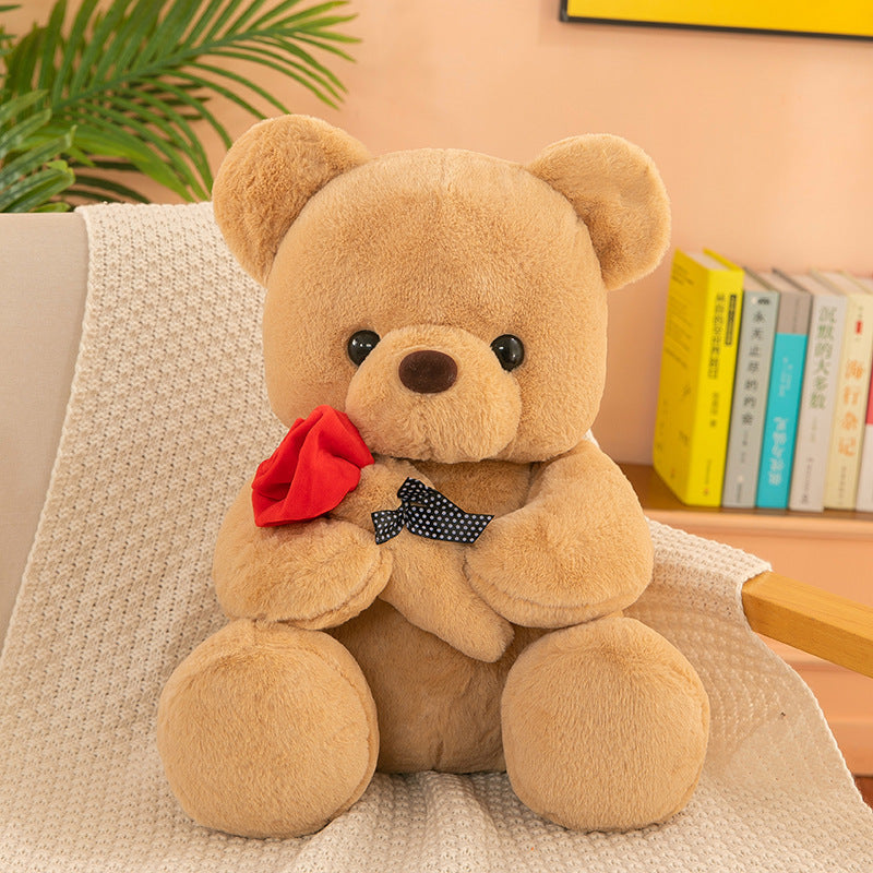 Teddy Bear with Rose – Soft plush bear with a rose, available in white, pink, brown, and gray, perfect for gifting on special occasions. Made with PP cotton and rabbit plush.