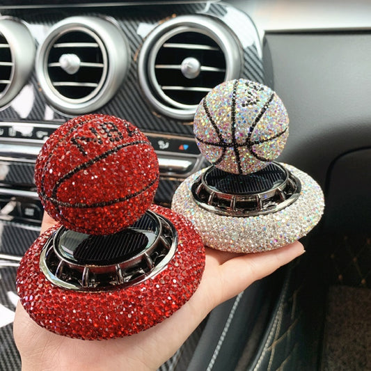 Solar-powered basketball ornament with diamond-encrusted design, rotating with sunlight. Includes solid aromatherapy for a pleasant fragrance. Available in red, white, and blue with a non-slip base.
