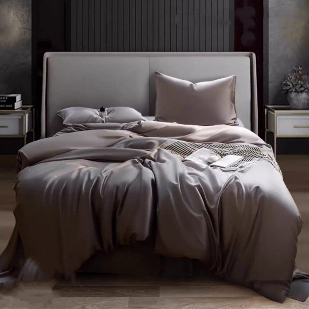 Luxuriously soft Four-Piece Ice Silk Bed Sheets made from breathable Lyocell fiber (Tencel). Features a modern minimalist design, reactive dyeing for long-lasting color, and a silky-smooth texture for year-round comfort. Available in multiple sizes.