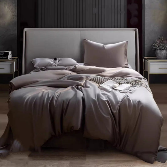 Luxuriously soft Four-Piece Ice Silk Bed Sheets made from breathable Lyocell fiber (Tencel). Features a modern minimalist design, reactive dyeing for long-lasting color, and a silky-smooth texture for year-round comfort. Available in multiple sizes.