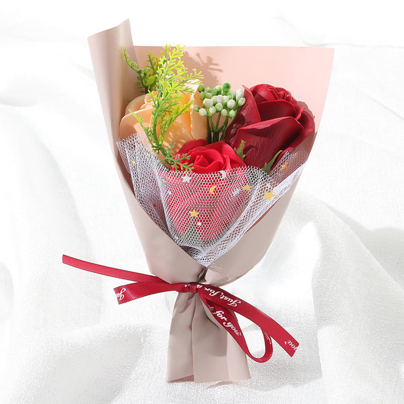 **"Elegant soap flower bouquet featuring delicate roses, forget-me-nots, and carnations, beautifully wrapped in premium paper with a gold ribbon. A timeless gift for weddings, birthdays, and special occasions."**