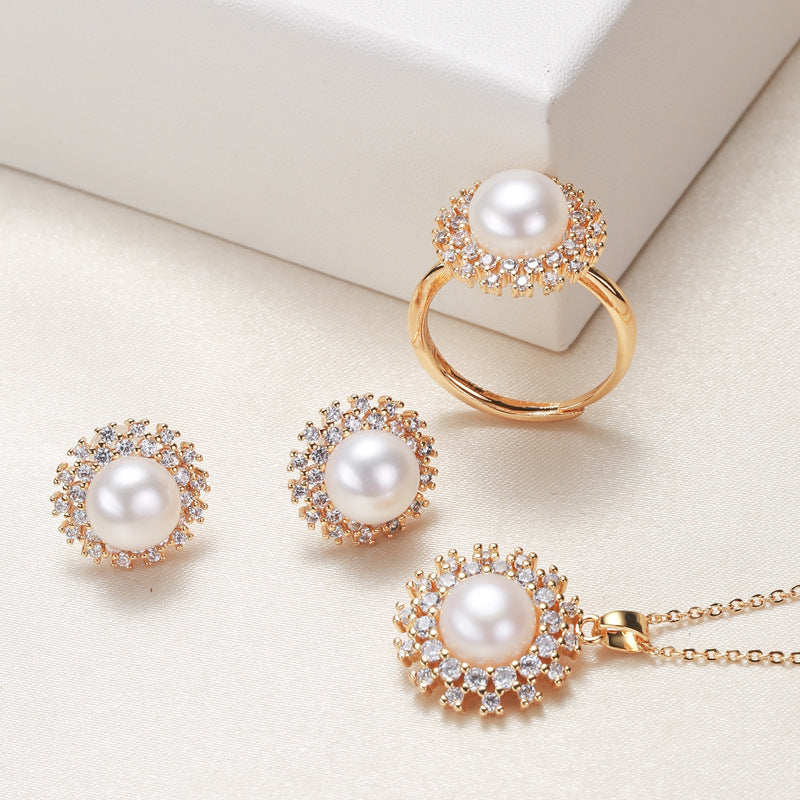 Elegant pearl necklace, ring, and earrings set in various color options, featuring timeless designs and luxurious craftsmanship