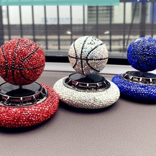 Solar-powered basketball ornament with diamond-encrusted design, rotating with sunlight. Includes solid aromatherapy for a pleasant fragrance. Available in red, white, and blue with a non-slip base.