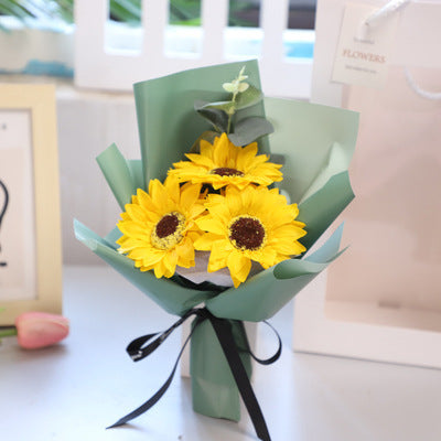 **"Elegant soap flower bouquet featuring delicate roses, forget-me-nots, and carnations, beautifully wrapped in premium paper with a gold ribbon. A timeless gift for weddings, birthdays, and special occasions."**