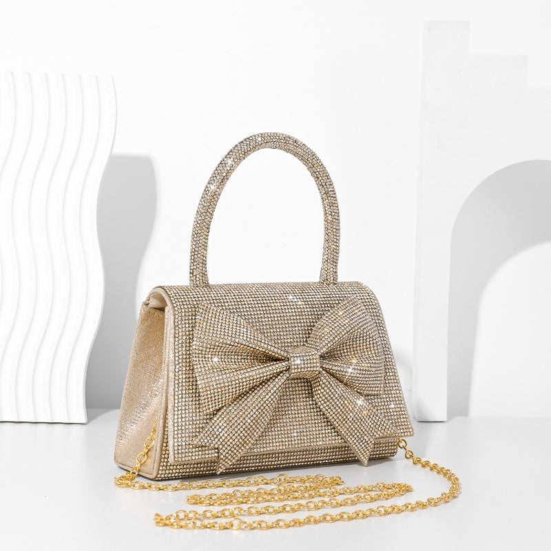 Step into the world of luxury and sophistication with the Elegant Full-Diamond Bow Handbag, a true statement piece that combines timeless elegance with a modern edge. Designed for the fashion-forward, this handbag is a stunning blend of street trend and light luxury style.