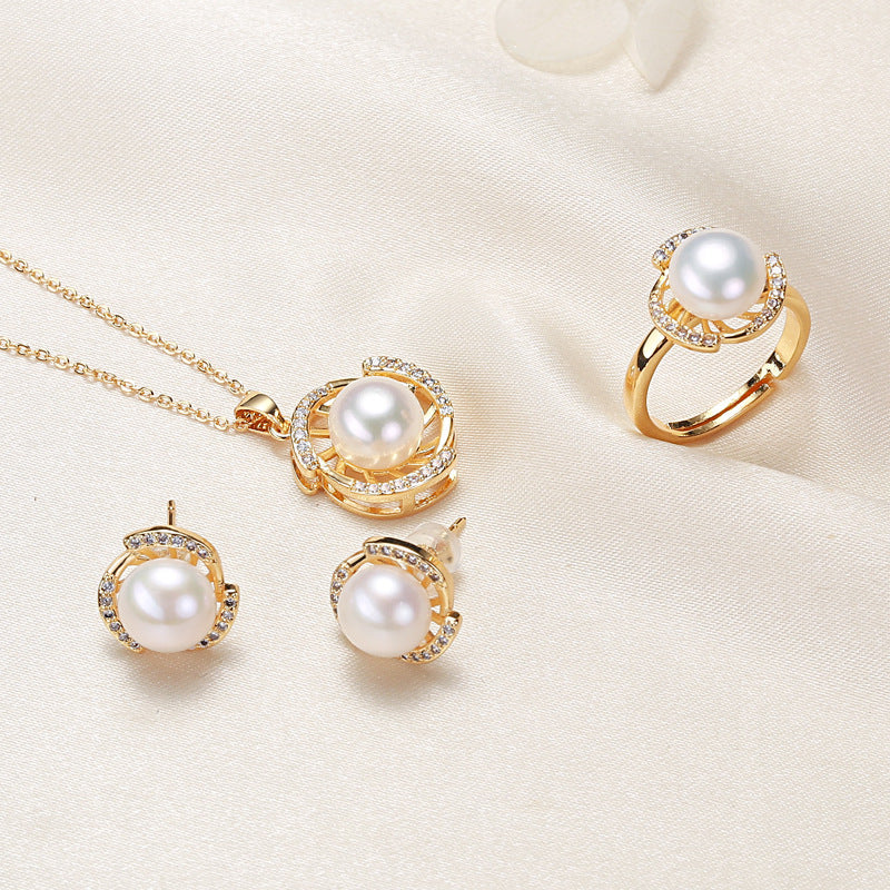 Elegant pearl necklace, ring, and earrings set in various color options, featuring timeless designs and luxurious craftsmanship